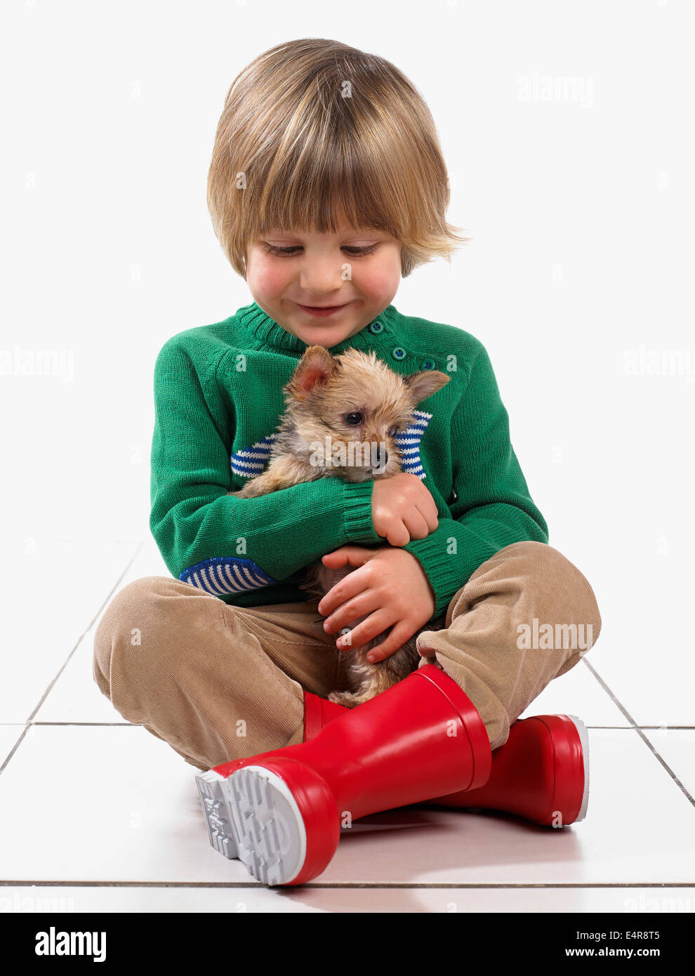 Boy (3 years) hugging puppy Stock Photo