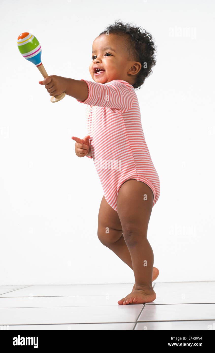 Toddler boy (18 months) holding a maraca Stock Photo
