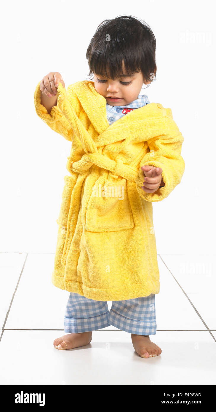 Small boy (16 months) wearing pyjamas and dressing gown Stock Photo
