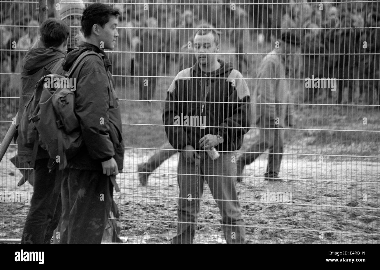 Man urinating against a fence at the Glastonbury Festival 1997