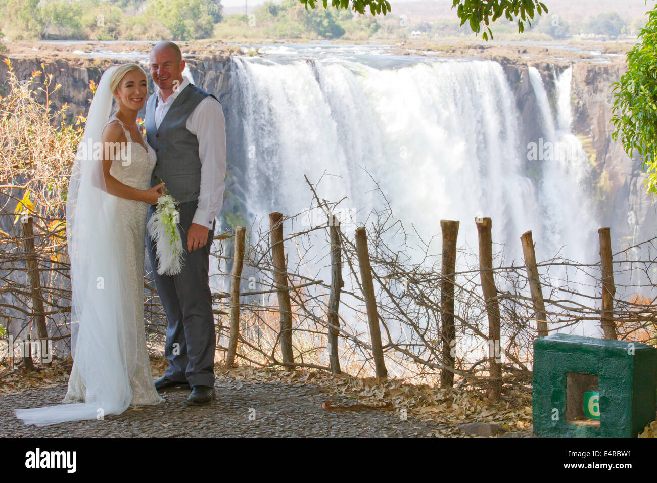 Bride and groom with the Victoria Falls in the background Stock Photo