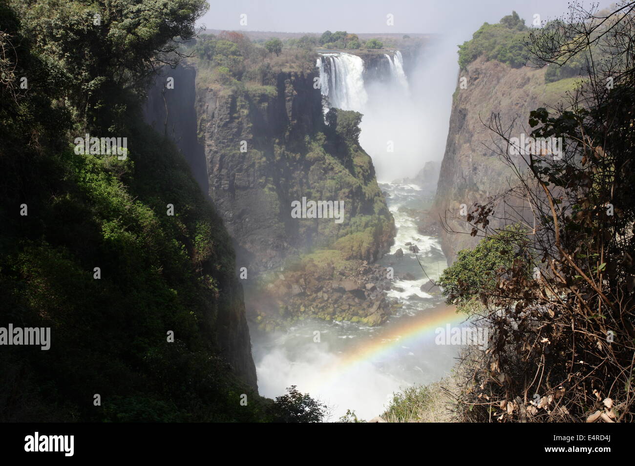 Victoria Falls the largest falls in the world with a rainbow in the foreground Stock Photo