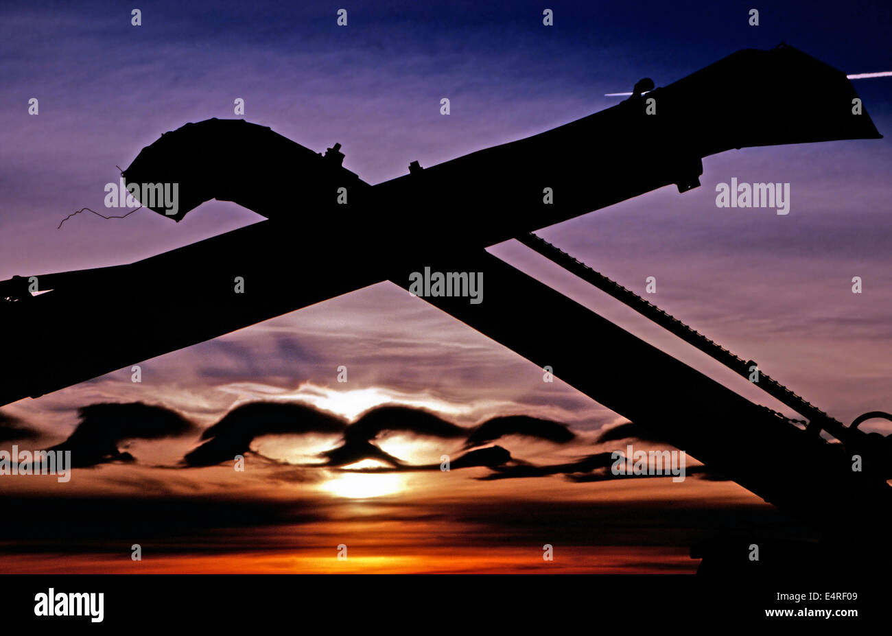 Unusual cloud formation framed by antique farm machinery,Saskatchewan Stock Photo