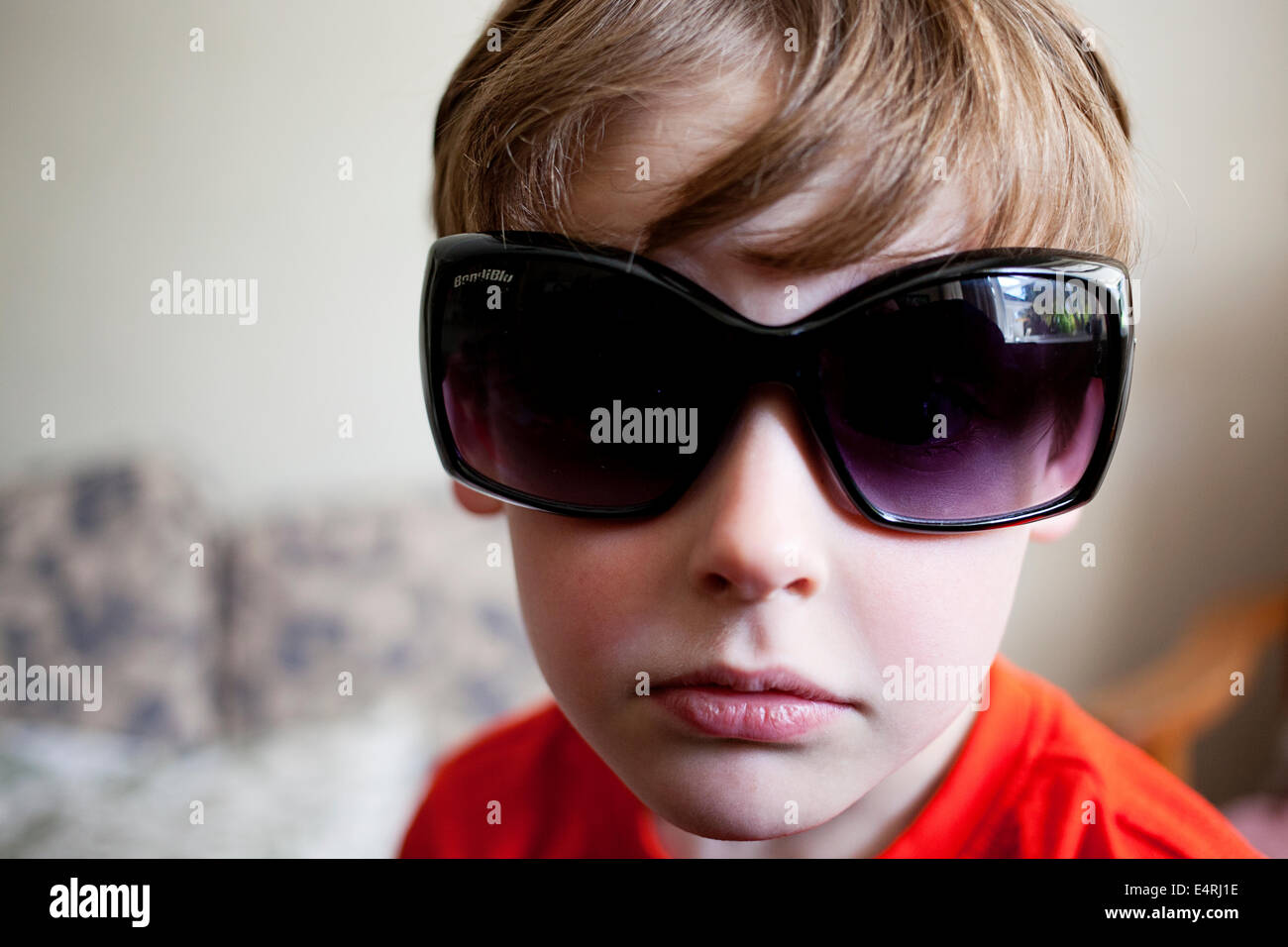 A young six year old boy wearing funny oversized dark sunglasses Stock Photo