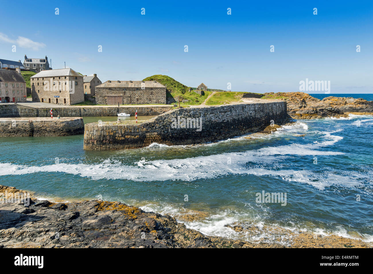 PORTSOY HARBOUR AT HIGH TIDE WITH WIND AND WAVES ABERDEENSHIRE COAST SCOTLAND Stock Photo