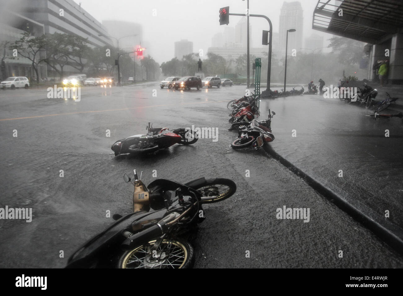 Manila, Philippines. 16th July, 2014. Motorcycles lie on the road toppled by strong winds as Typhoon Rammasun hit Metro Manila on July 16, 2014. Typhoon Rammasun (locally known as Glenda) had maximum sustained winds of 150 kph and gustiness of up to 185 kph when it hit Metro Manila. Across the country, about 400,000 people had fled their homes and sheltered in evacuation centers, according to the disaster management council. Credit:  ZUMA Press, Inc./Alamy Live News Stock Photo