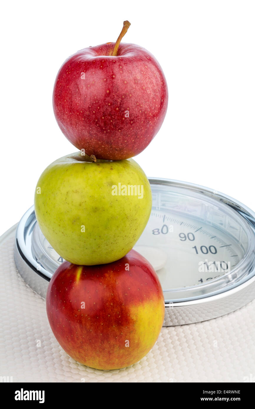 Several apples on scales for people. Symbolic photo for diet and healthy, high vitamin food., Mehrere Aepfel auf einer Waage fue Stock Photo