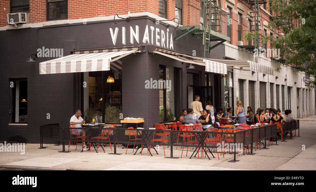 Patrons sit at the outdoor cafe of the Vinateria restaurant on Frederick Douglass Blvd in the