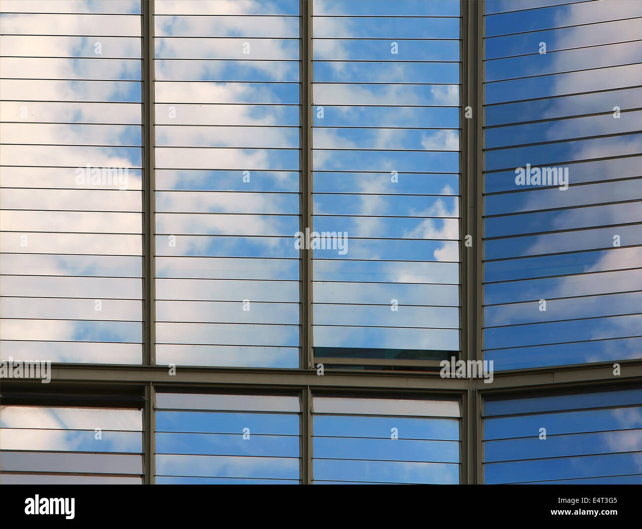 Clouds reflected in windows of modern office building Stock Photo - Alamy
