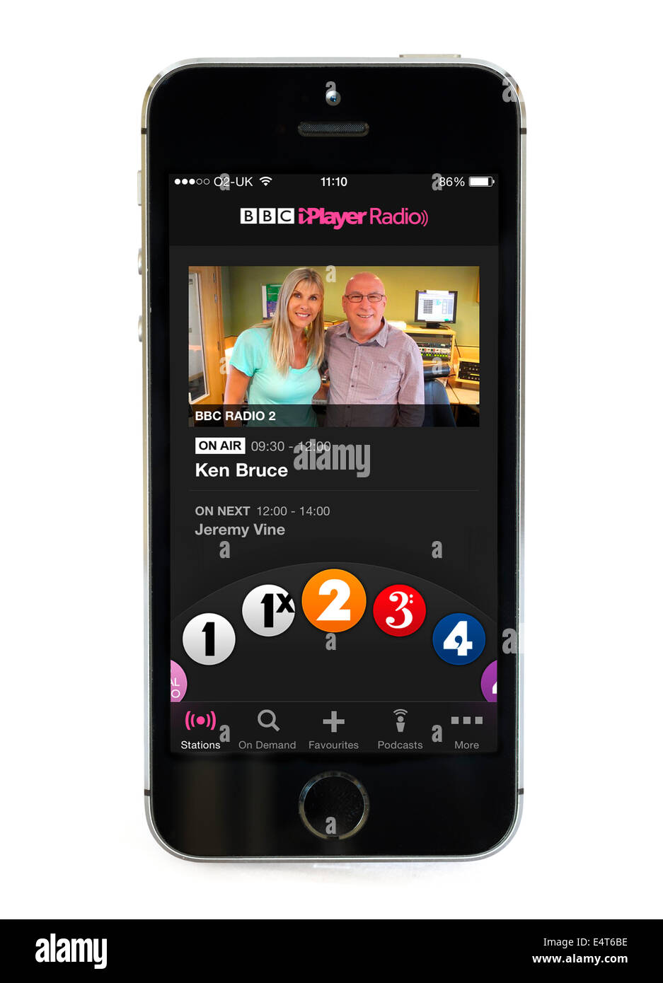 Listening to the Ken Bruce show via the BBC iPlayer Radio app on an Apple iPhone 5S, UK Stock Photo