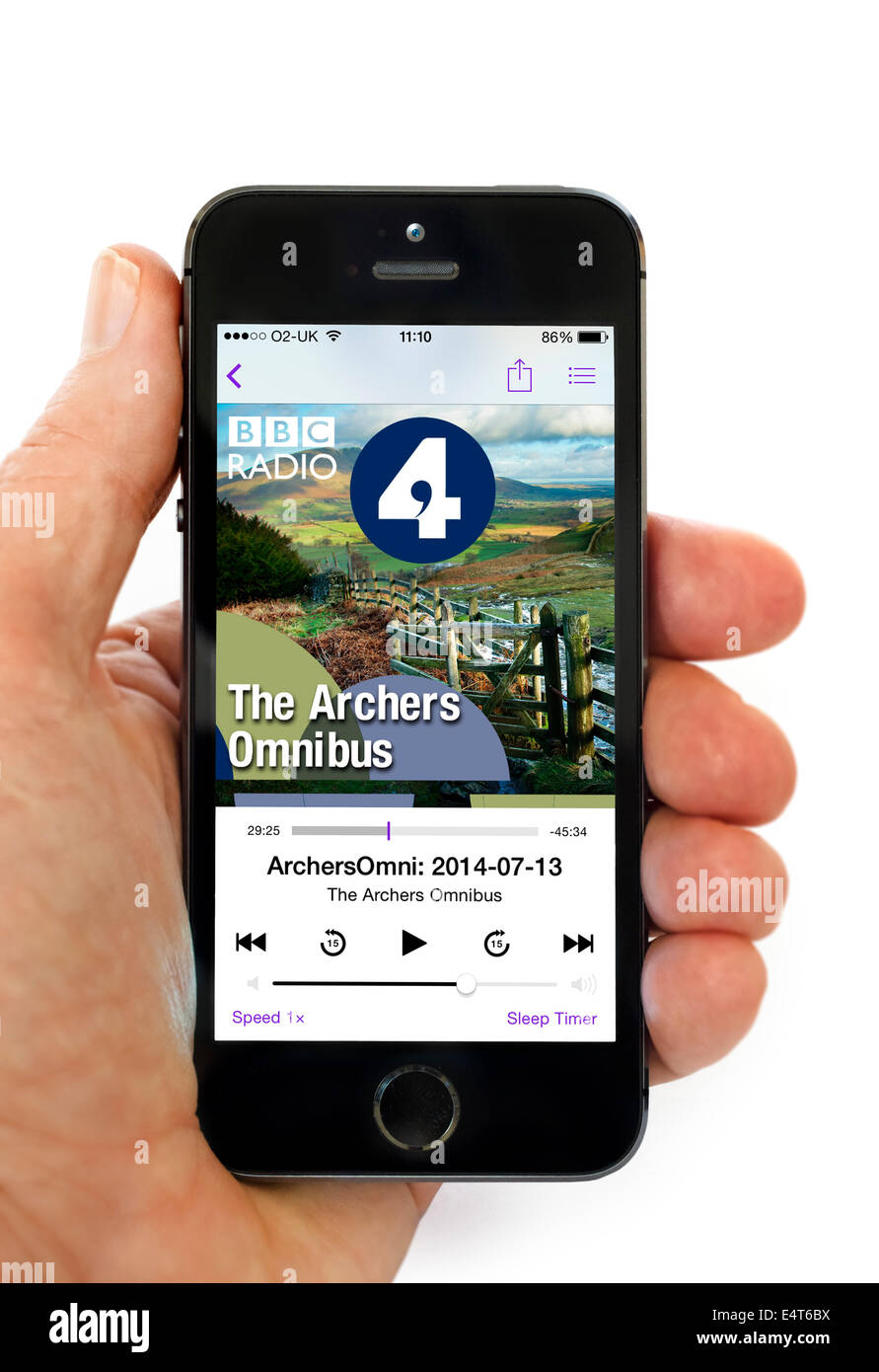 Listening to the Archers Omnibus via the Podcast app on an Apple iPhone 5S Stock Photo