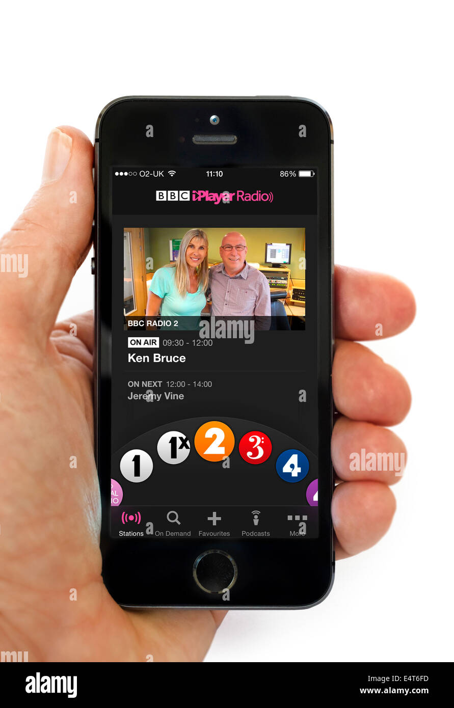Listening to the Ken Bruce show via the BBC iPlayer Radio app on an Apple iPhone 5S, UK Stock Photo