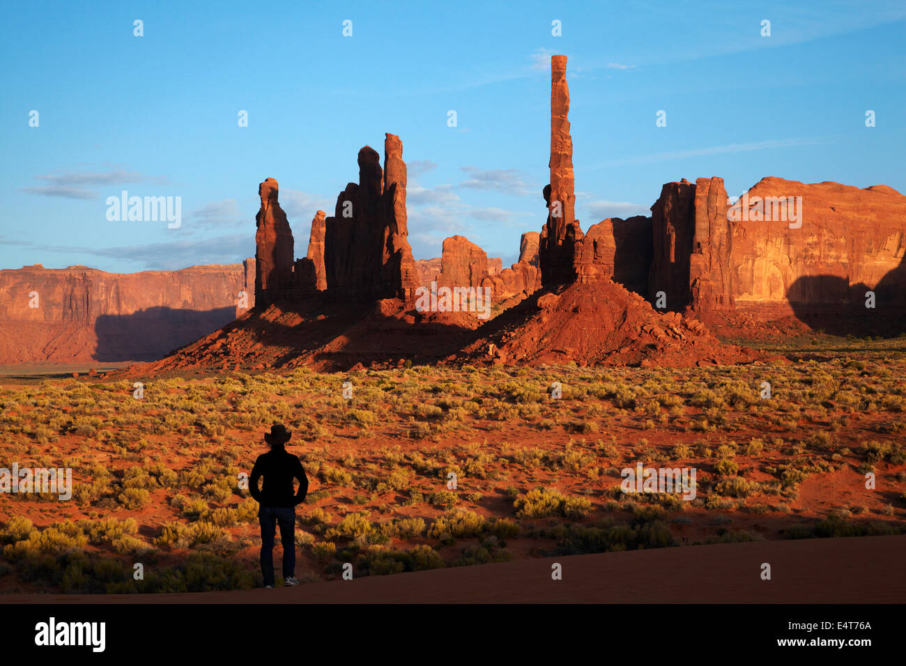 Yei Bi Chei and Totem Pole rock columns, and tourist, Monument Valley, Navajo Nation, Arizona, near Utah border, USA Stock Photo