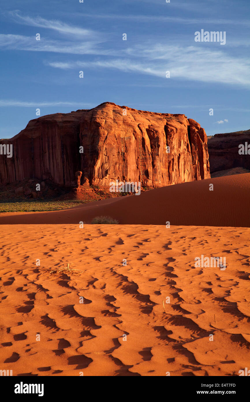 Sand dunes and rock outcrop, Monument Valley, Navajo Nation, Utah/Arizona Border, USA Stock Photo