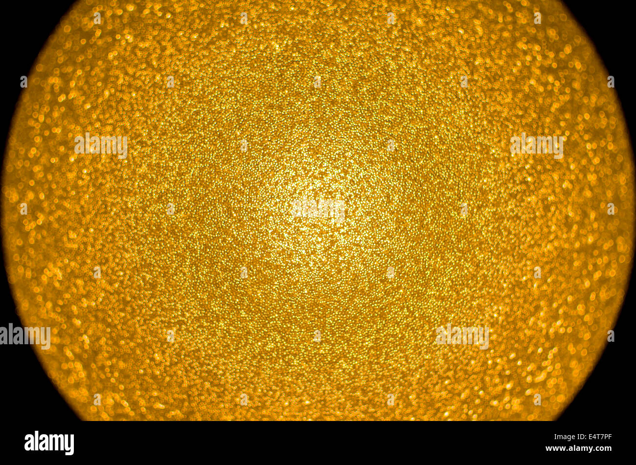 Gold Colored Glistening Sphere Centered in the Dark Stock Photo