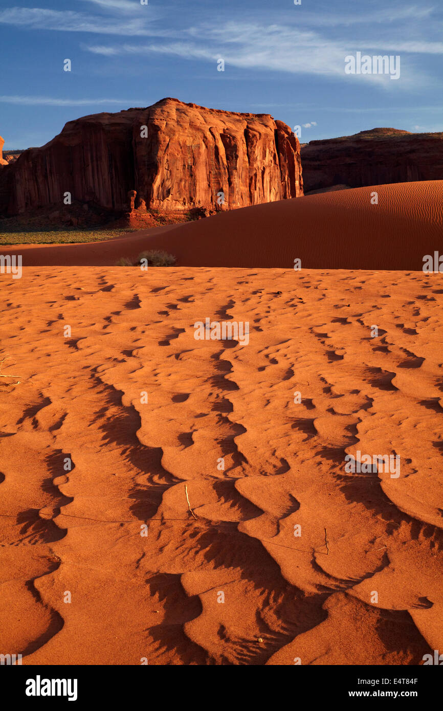 Sand dunes and rock outcrop, Monument Valley, Navajo Nation, Utah/Arizona Border, USA Stock Photo