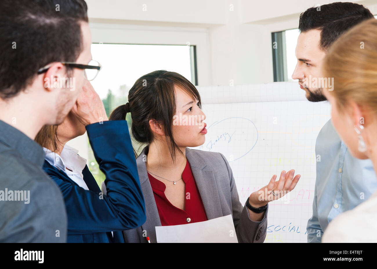 Close-up of young business people in disucssion in office, Germany Stock Photo