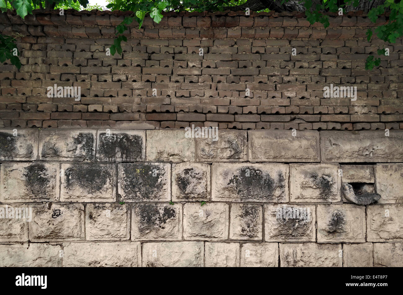 Background of old tiled fence from stone and brick, Razgrad, Bulgaria Stock Photo
