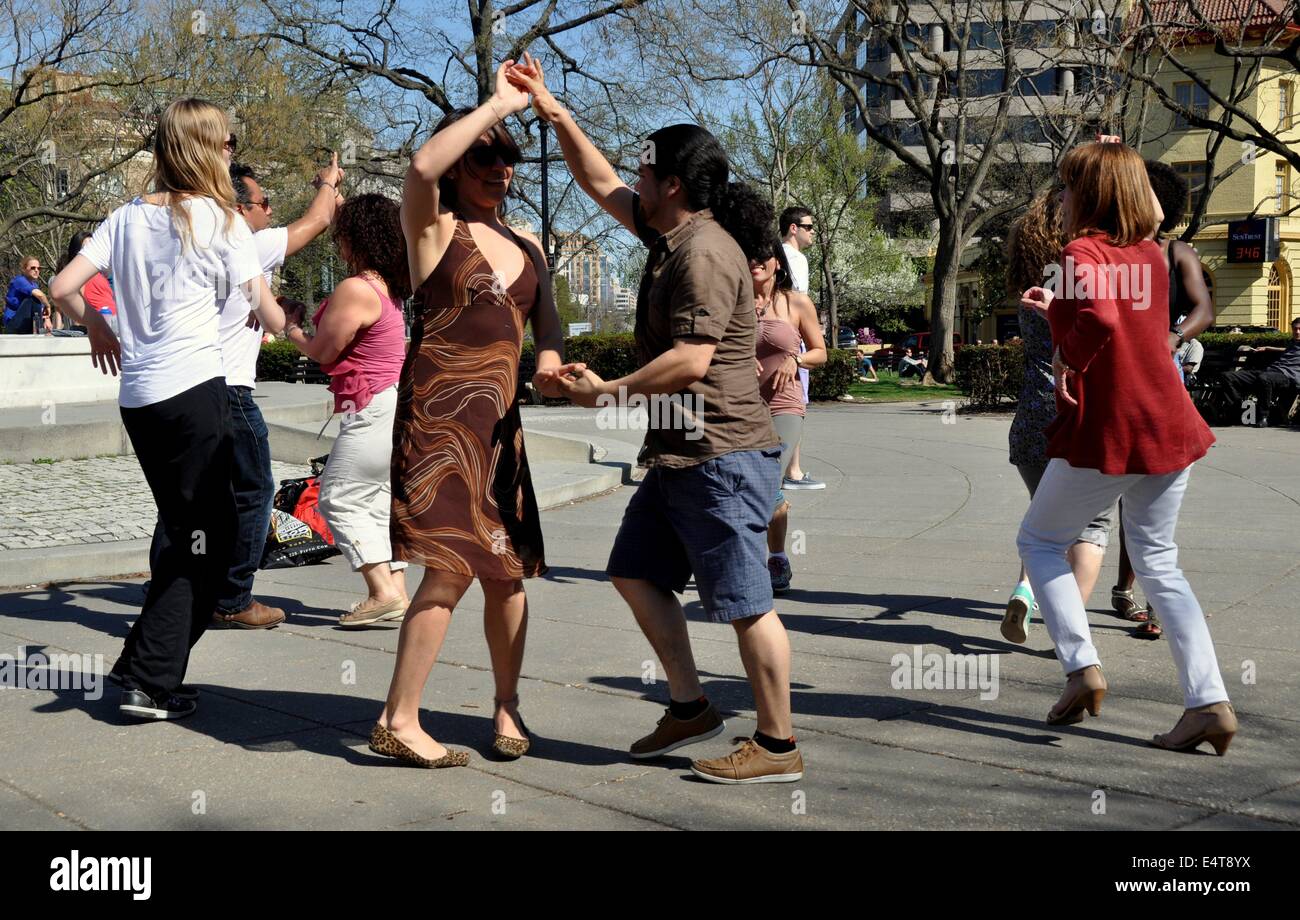 Washington, DC:  Group of people Salsa dancing on the plaza at Dupont Circle on a warm Spring afternoon Stock Photo
