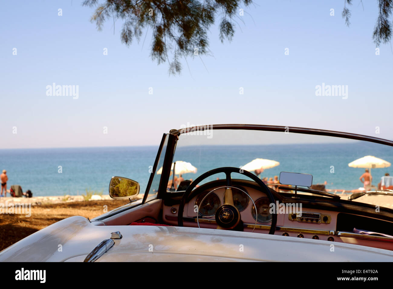 Classic convertible open top white Alfa Romeo sports car - parked at a beach - Mani Peninsula, Peloponnese, Greece Stock Photo