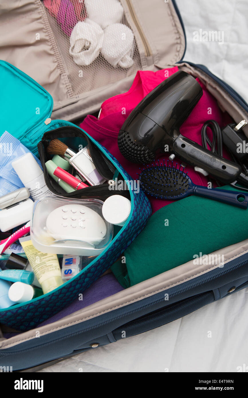 Women's Toiletry Travel Bag in Packed Suitcase Stock Photo