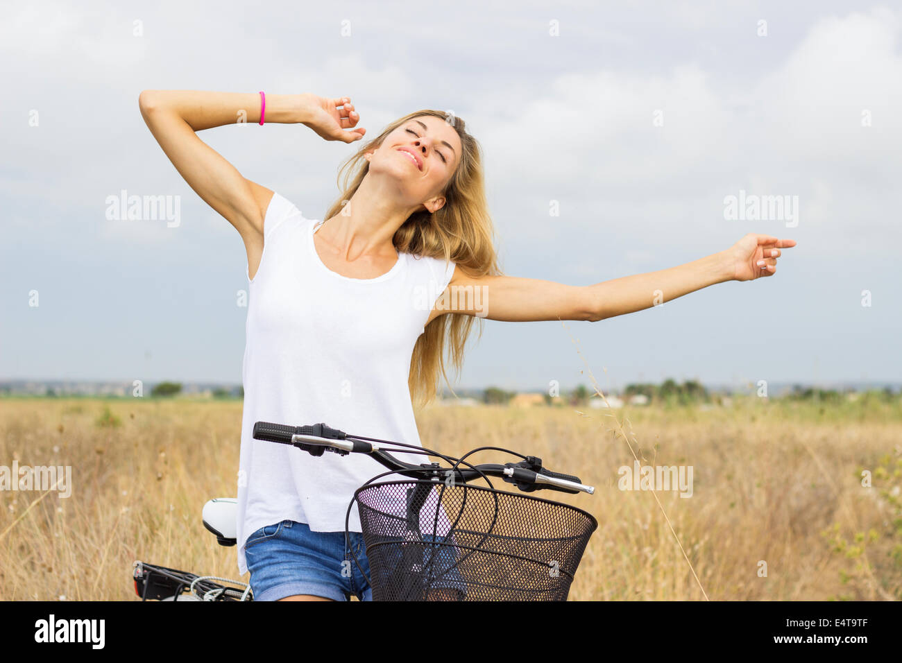 young beautiful woman relaxing enjoying free freedom countryside bicycle nature outdoor natural beauty "white t-shirt" Stock Photo