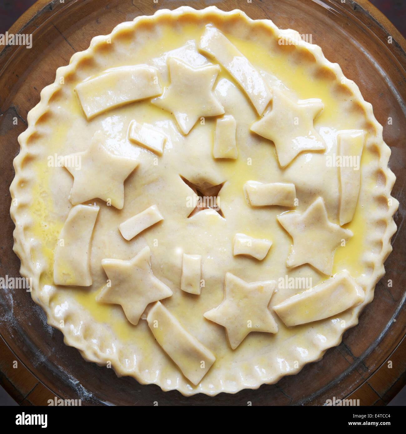 Overhead view of unbaked apple pie with star shaped cut-outs on top, studio shot Stock Photo