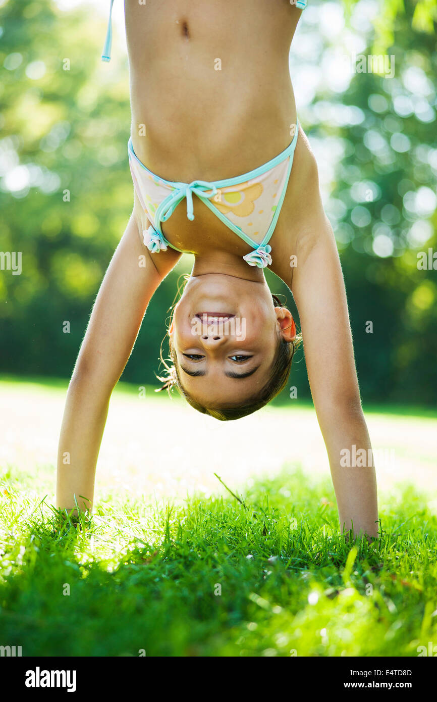 Close-up portrait of young girl doing a handstand on grass, Lampertheim,  Hesse, Germany Stock Photo - Alamy
