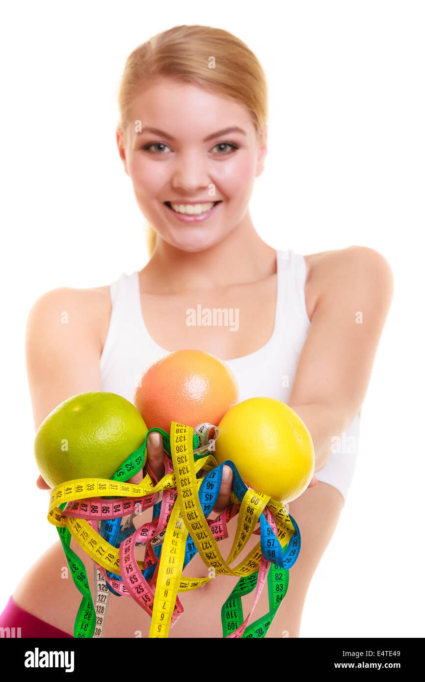 Fitness woman fit girl holding colorful measure tapes fruit Stock Photo