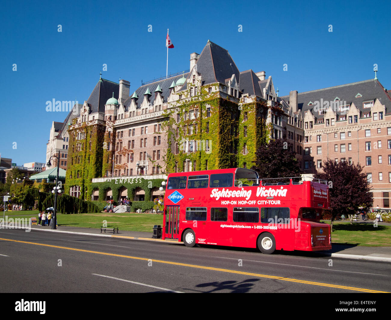 A view of the Fairmont Empress Hotel and a Gray Line double-decker sightseeing bus in Victoria, British Columbia, Canada. Stock Photo