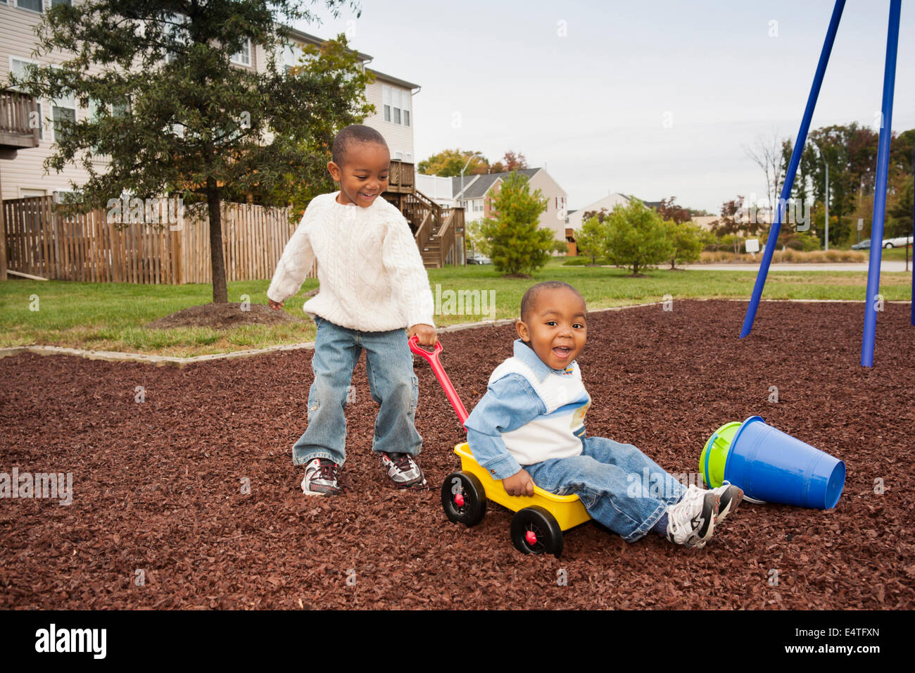 Boy Pulling Younger Brother in Wagon at Playground, Maryland, USA Stock ...
