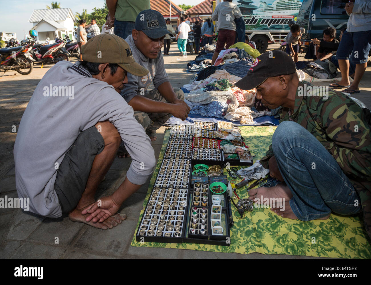 Jimbaran, Bali, Indonesia.  Potential Customers Examine Vendor's Selection of Rings and Necklaces. Stock Photo