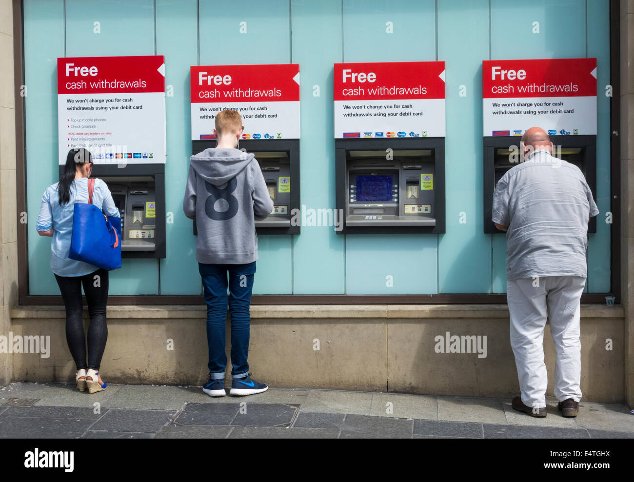 People using HSBC city centre ATM machines. Newcastle upon Tyne, England, UK Stock Photo