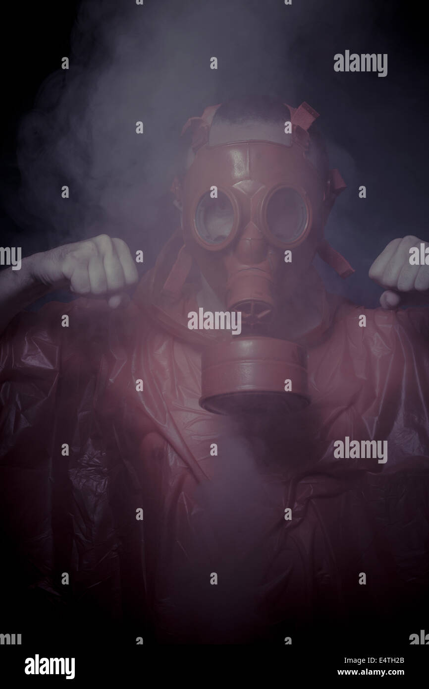 Respirator, nuclear disaster, man with red mask and plastic suit Stock
