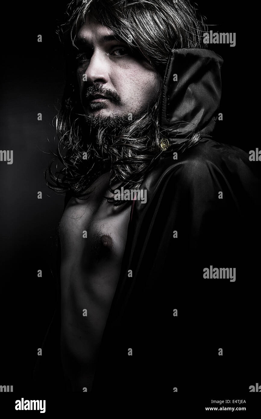 Vampire with black coat and long hair Stock Photo - Alamy