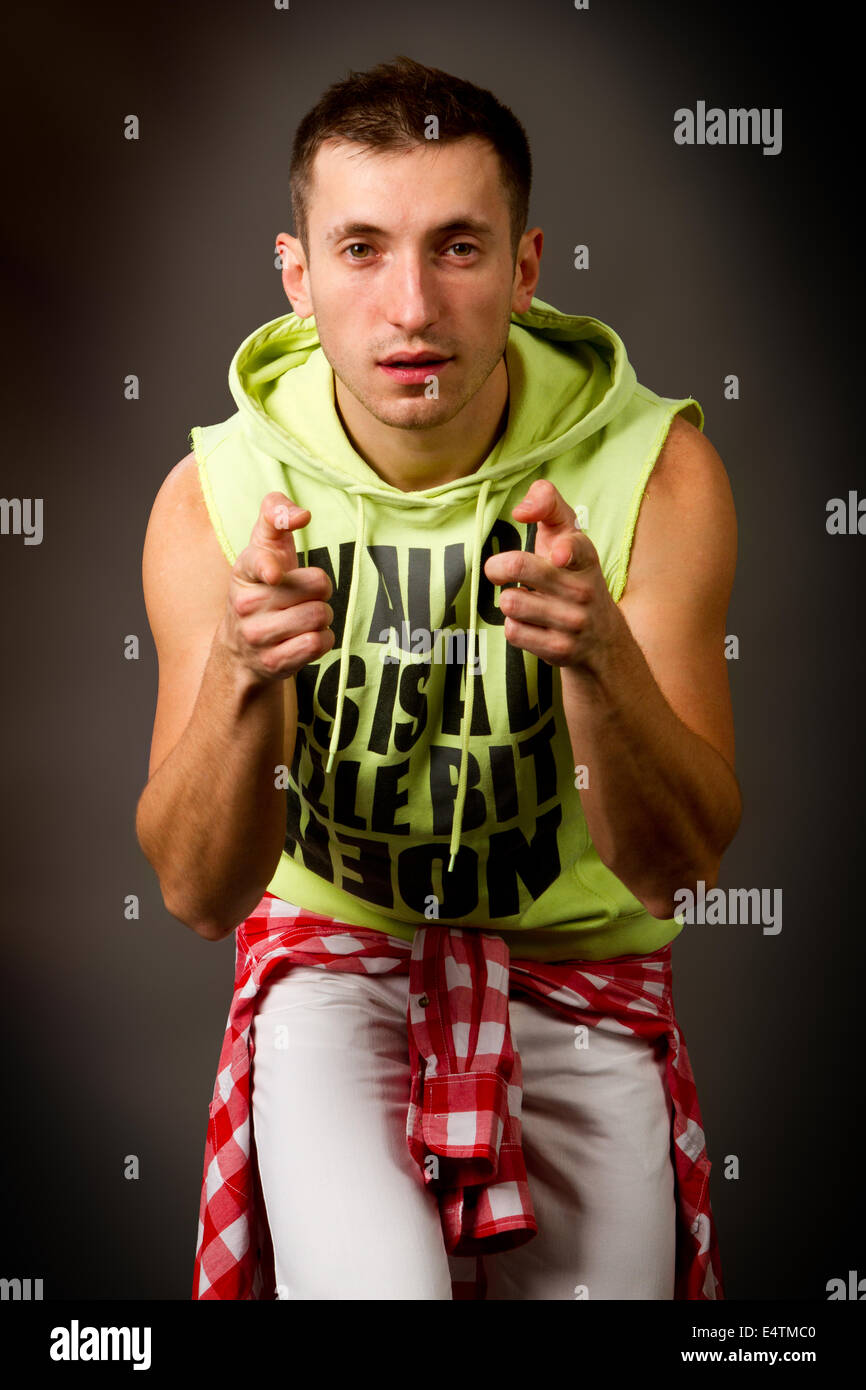 young guy in a green jacket on a black background Stock Photo