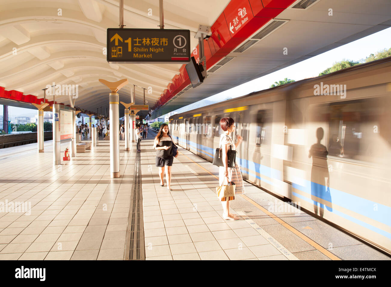 A woman waiting for an arriving train at the Shilin Metro (MRT) Station on July 7, 2014 in Taipei, Taiwan. (CTK Photo/Karel Picha) Stock Photo