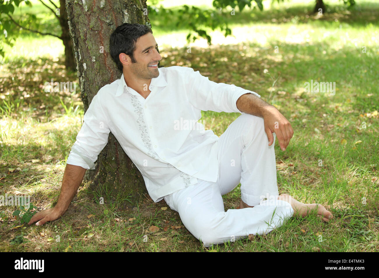 35 years old lying down under a tree Stock Photo