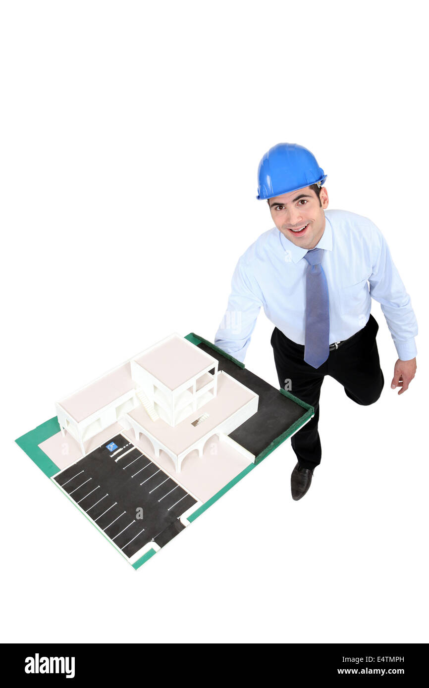 businessman holding a model of a building Stock Photo - Alamy