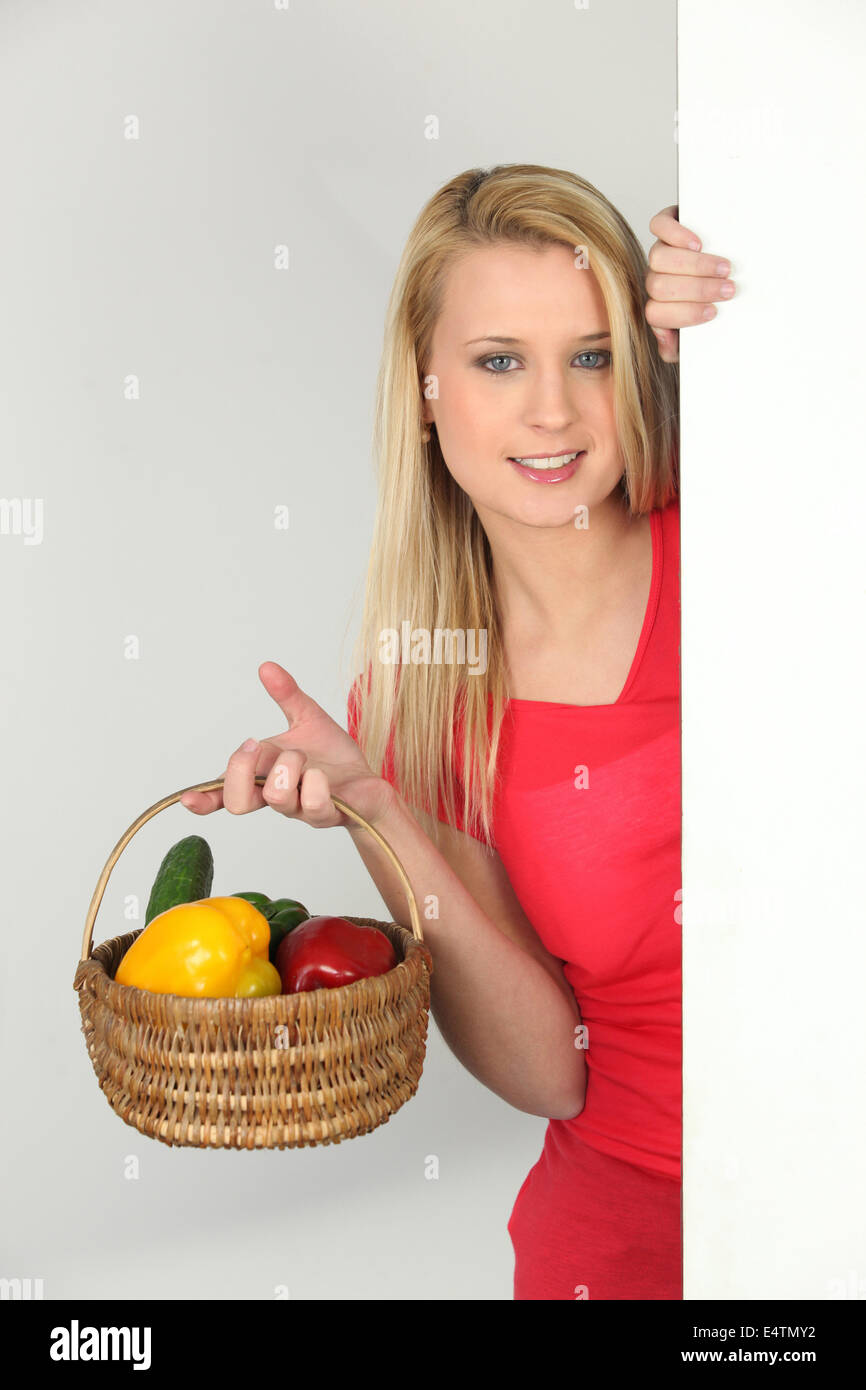 Teenage girl with basket of vegetables Stock Photo - Alamy