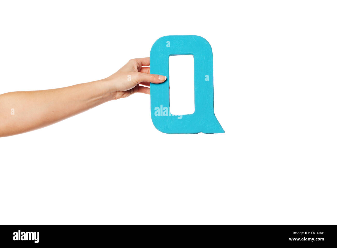 hand holding up the letter Q from the left Stock Photo