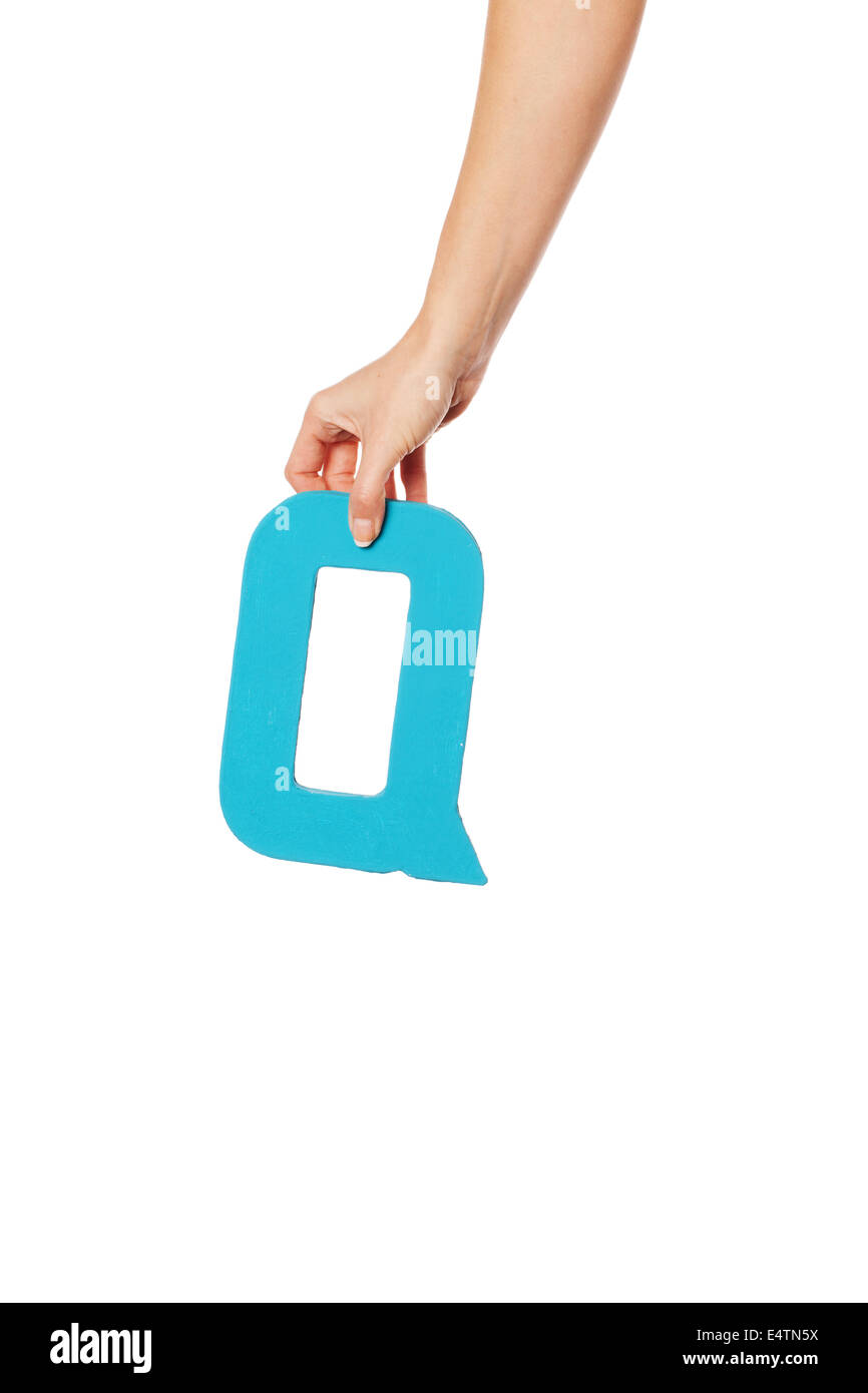 hand holding up the letter Q from the top Stock Photo