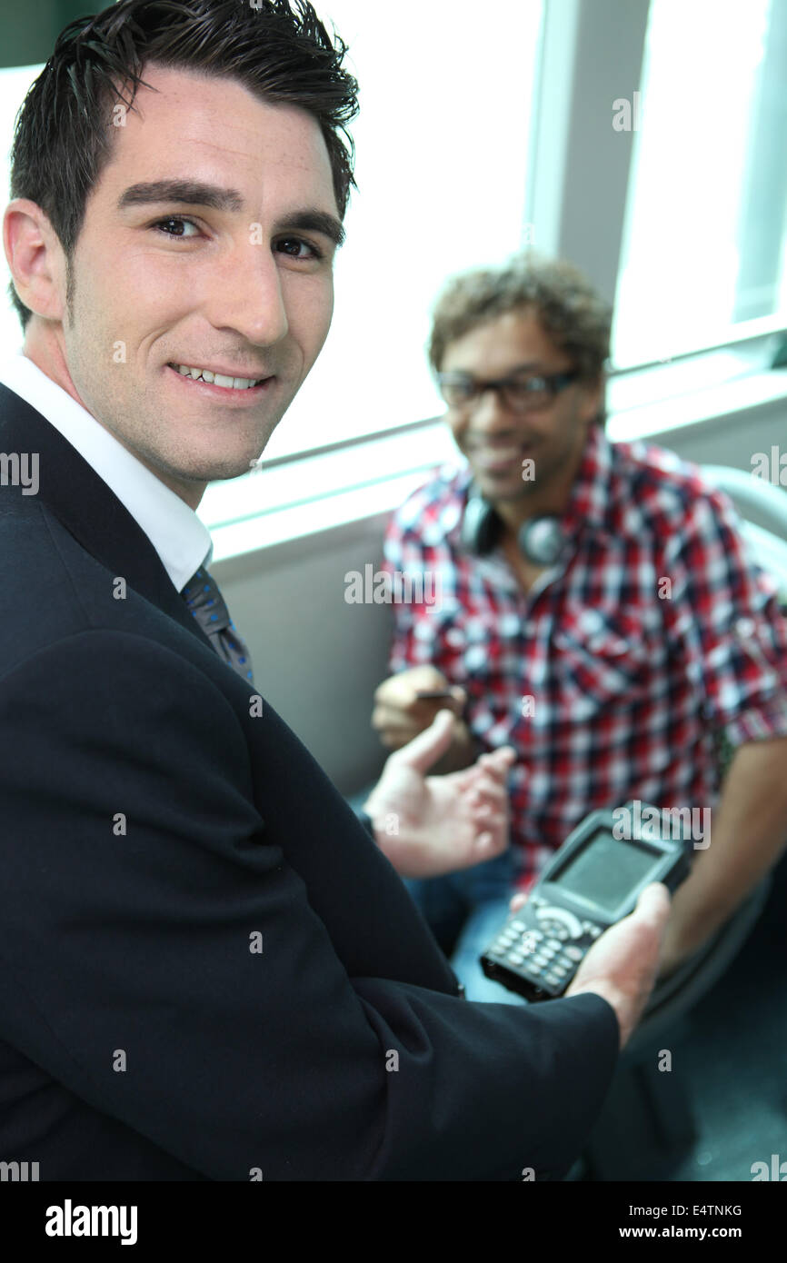 Man checking tickets on a train Stock Photo