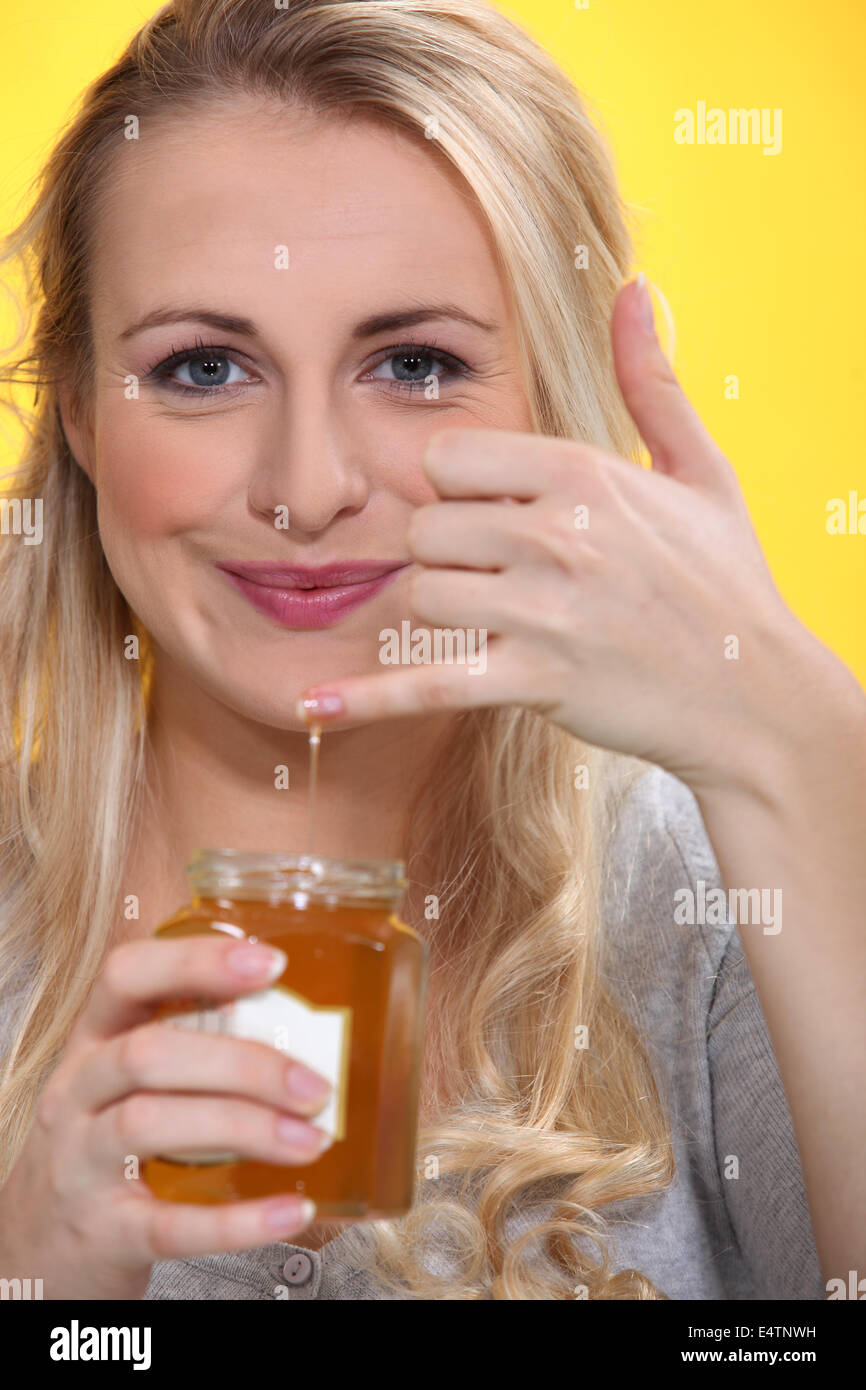 Smiling woman holding a honeypot Stock Photo