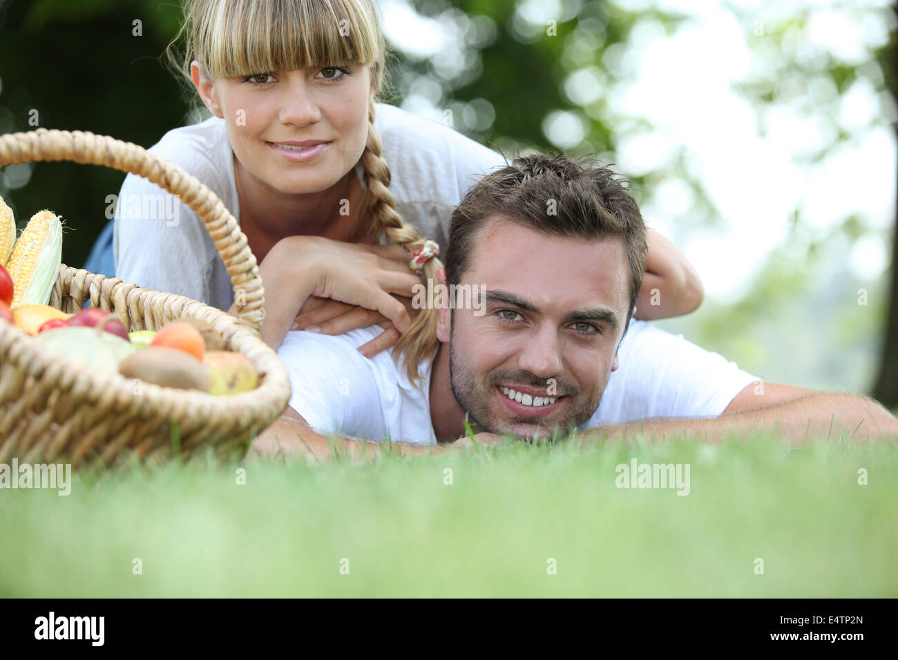 Young couple having a picnic in the park Stock Photo - Alamy