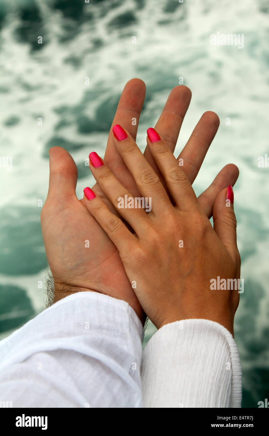 Men's and Women's tanned hands Stock Photo