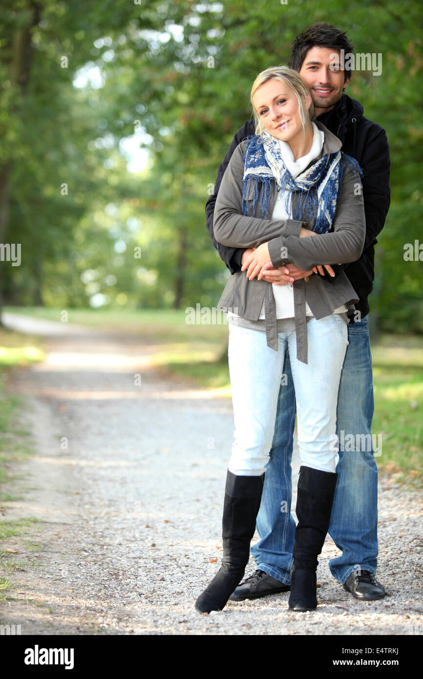 Couple hugging on a forest path Stock Photo - Alamy