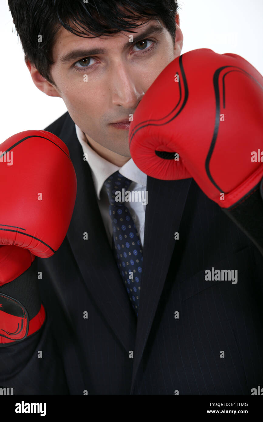 Businessman wearing boxing gloves Stock Photo Alamy