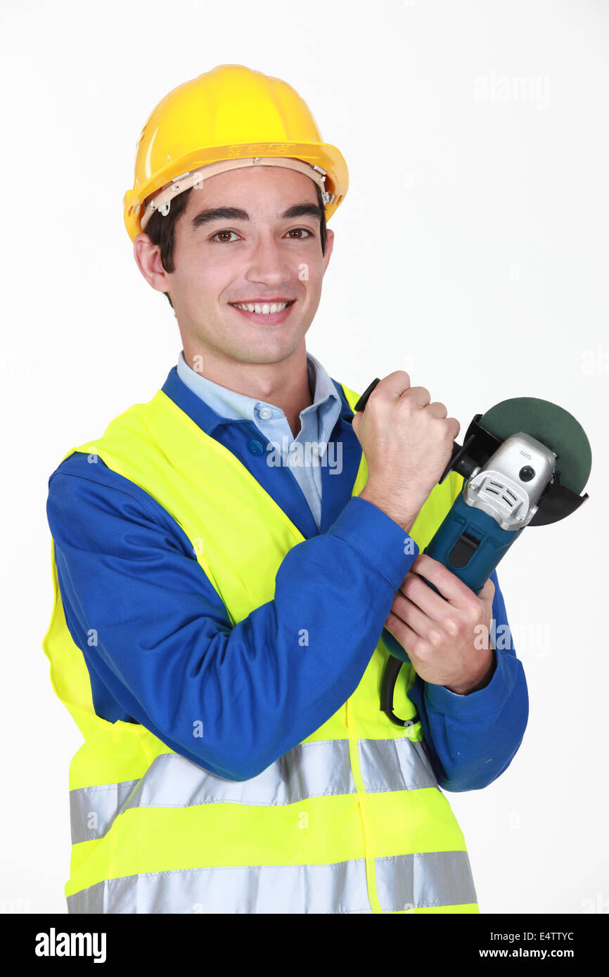 Tradesman holding an angle grinder Stock Photo Alamy