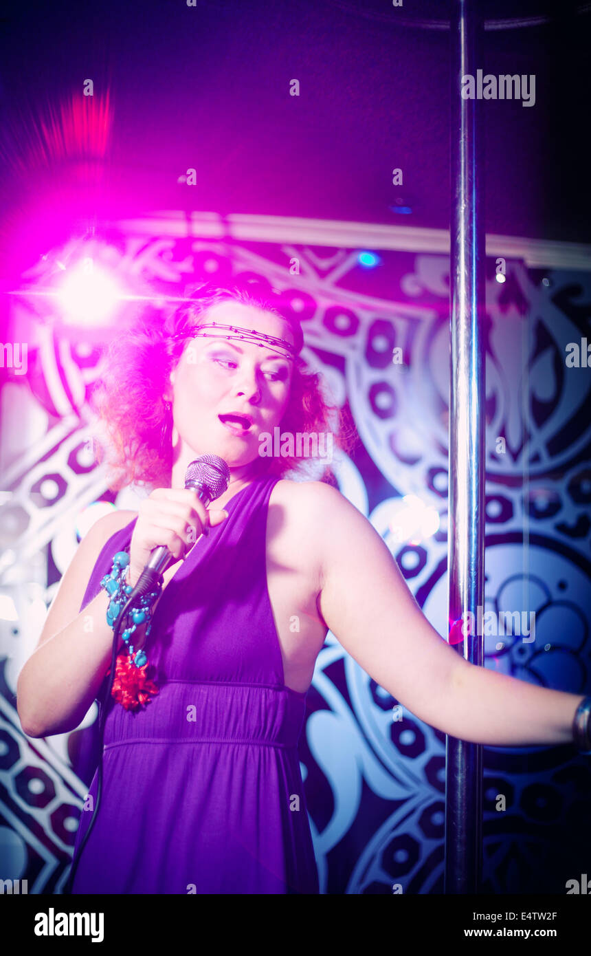 A Young and very beautiful woman singing Stock Photo